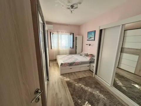 Furnished bedroom with a double bed and large wardrobes. - image 8
