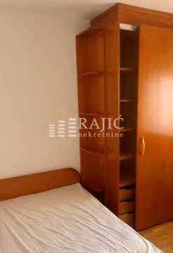 Bedroom with a wooden bed and a wardrobe. - image 8