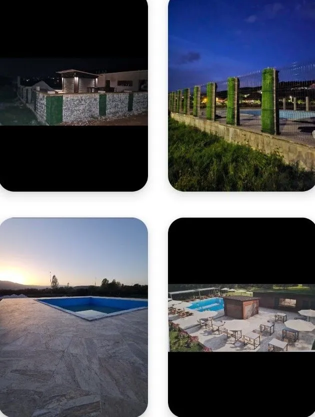 View of the exterior of the property with a swimming pool and terrace at night.