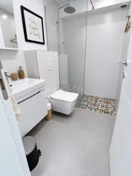 Modern bathroom with a walk-in shower, washbasin, and toilet. - image 6