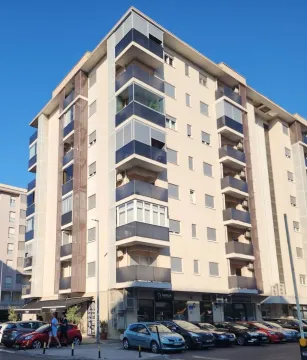 Pogled na spoljašnost stambene zgrade sa terasama i parkiranim automobilima ispred. - image 6