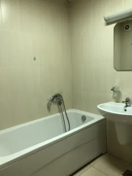 Bathroom with a bathtub and sink. - image 11
