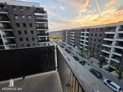 Balcony view of the street and modern residential buildings. - image 13