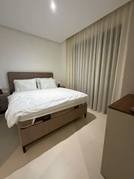 Modern bedroom with a double bed and light curtains. - image 10