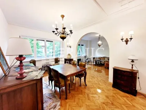 Spacious living room with a dining area and parquet flooring. - image 7