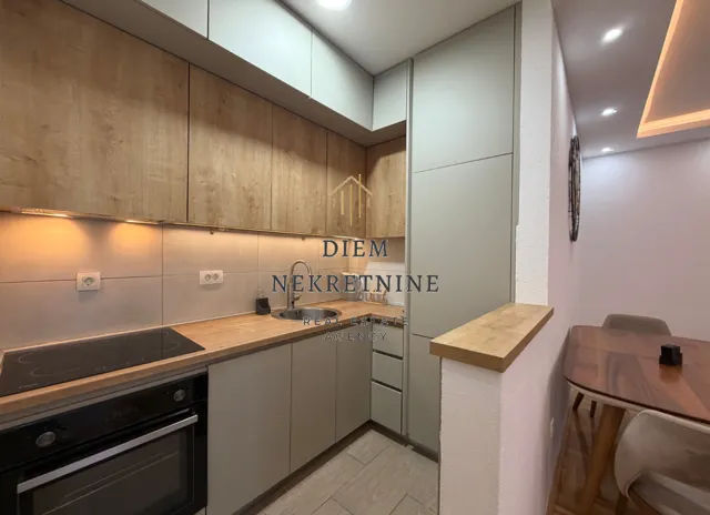 Modern and bright kitchen with wooden elements and built-in appliances.