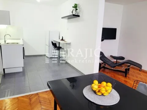 Living room with dining area and kitchen in light tones. - image 4