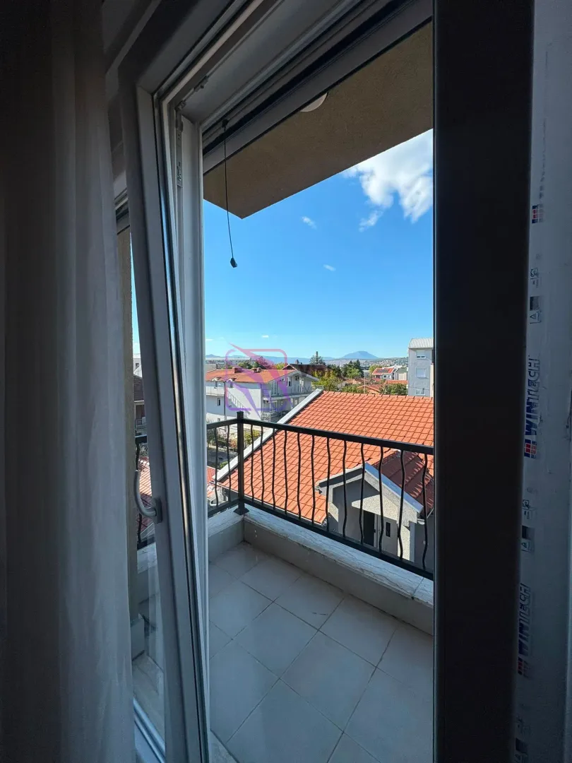 View from the balcony overlooking surrounding buildings and the neighborhood.