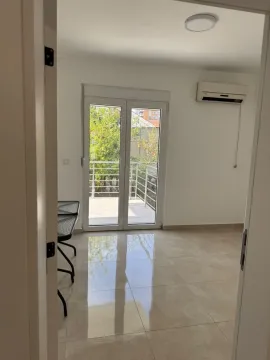 Bright room with ceramic tile flooring and balcony access. - image 11