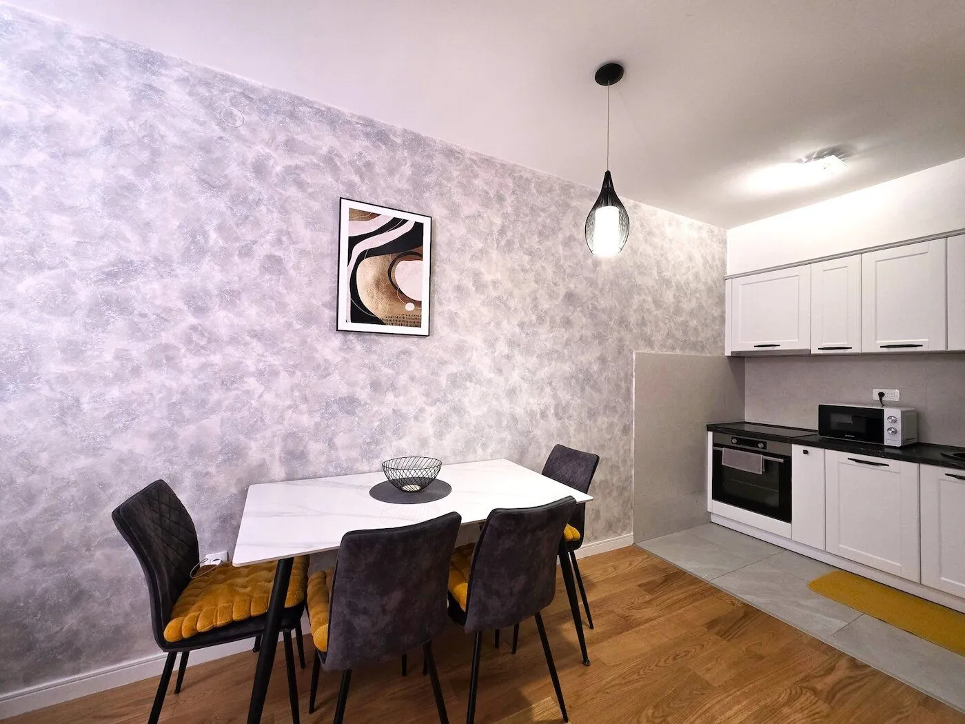 Kitchen with a dining table and white cabinets.