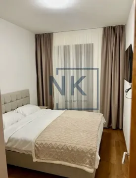 Furnished bedroom with a double bed and a window with curtains. - image 5