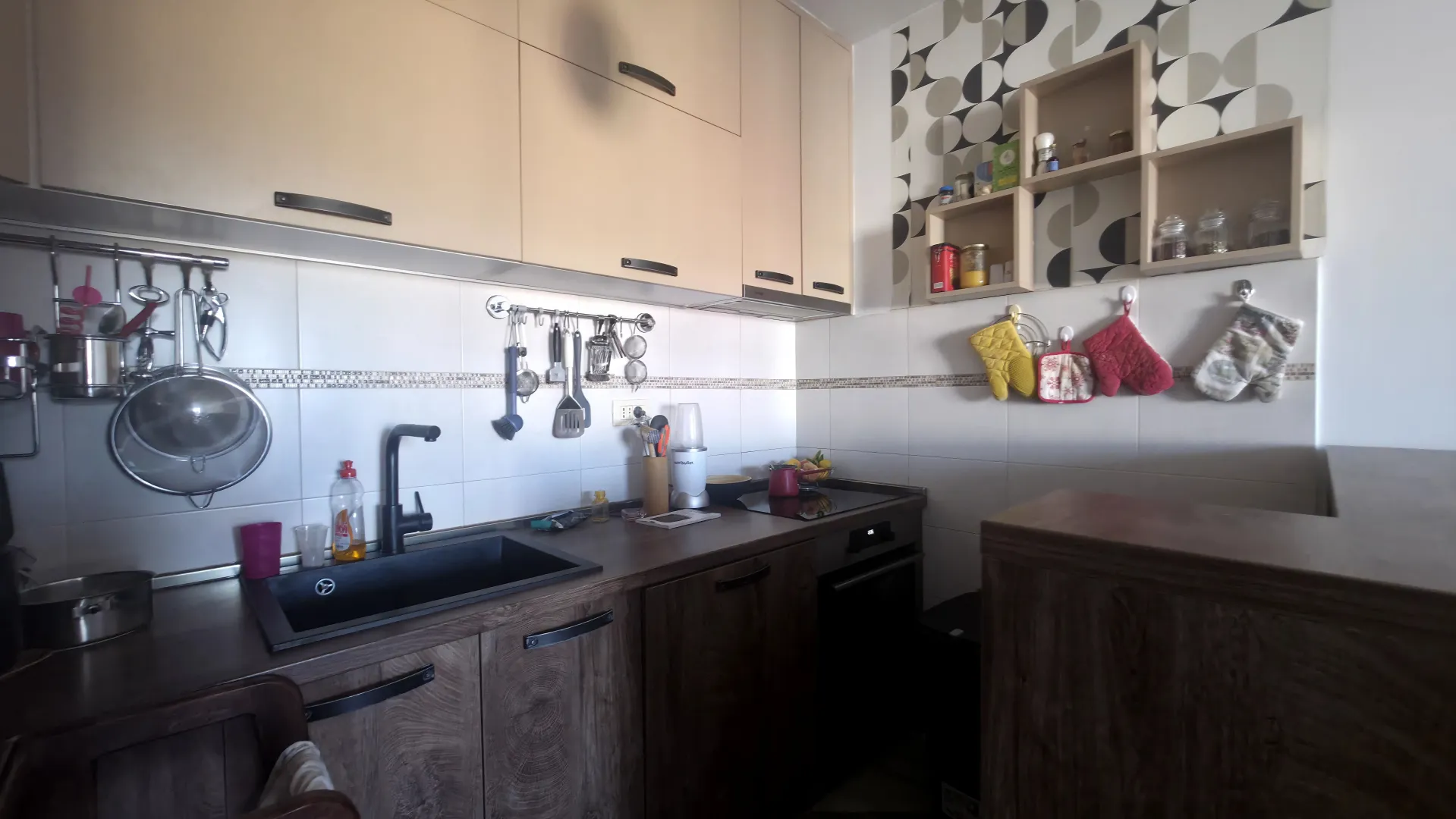 Small kitchen with wooden cabinets and a dark countertop.