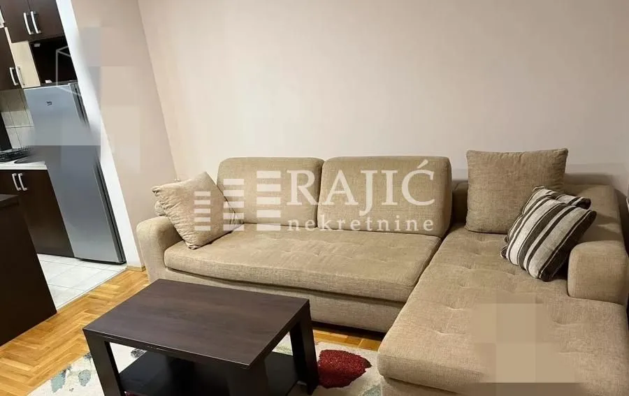 Living room with a sectional sofa and a coffee table.