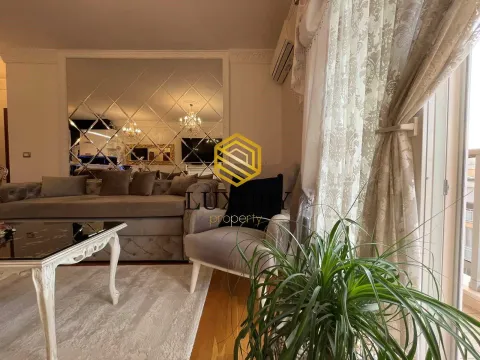 Living room with a sofa set, coffee table, and a decorative wall mirror. - image 2