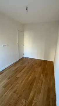 Empty room with white walls and wooden flooring. - image 5