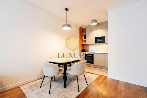 Modern dining area with a table and chairs connected to the kitchen. - image 5