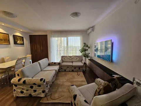 Living room with a seating area, TV and a dining area in the background. - image 13