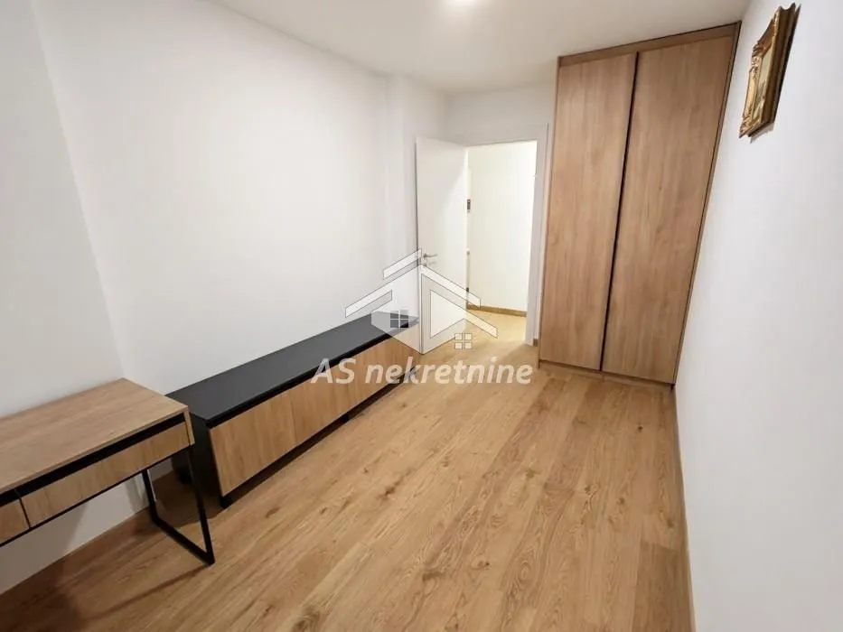 Smaller bedroom with a built-in wardrobe and a chest of drawers.