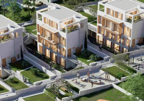 Pogled iz vazduha na kompleks modernih zgrada sa uređenim dvorištem i igralištem. - image 10