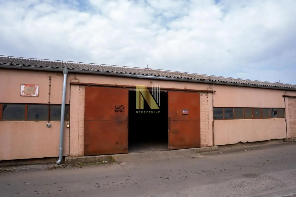 Exterior of an industrial building with sliding metal doors.