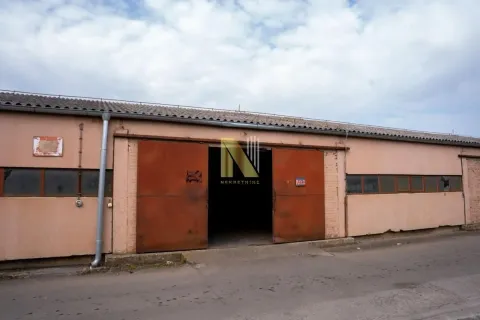 Exterior of an industrial building with sliding metal doors. - image 2