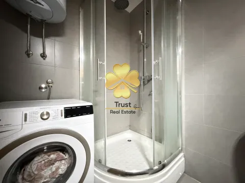 Modernly equipped bathroom with a shower cabin and washing machine. - image 10