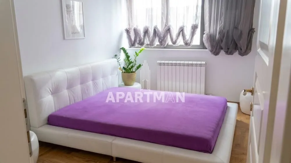 Bedroom with a large double bed and a window.