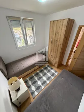 Smaller bedroom with two beds, a wardrobe, and a window. - image 7