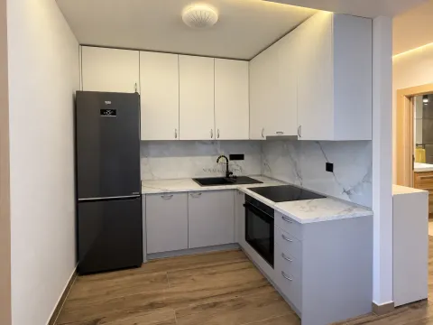 Modern kitchen with gray cabinets and a black refrigerator. - image 4
