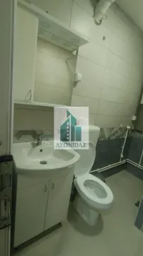 Small bathroom with a sink, cabinet, and toilet. - image 9
