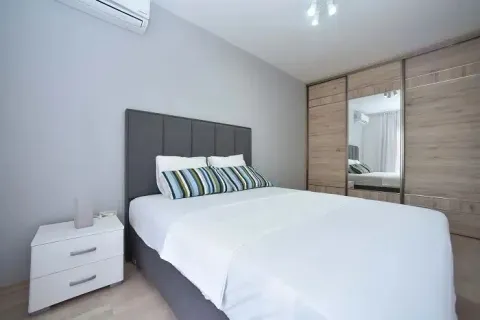 Bedroom with a double bed, nightstand, and built-in wardrobe with a mirror. - image 5