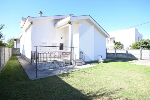 View of the yard and the back side of the house with a terrace. - image 2