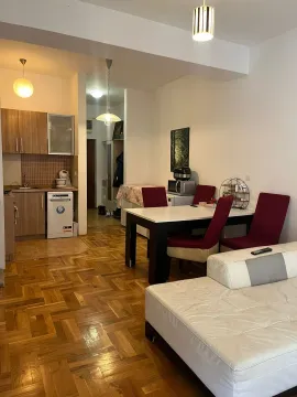 Living room with dining area and kitchen in an open plan space. - image 4