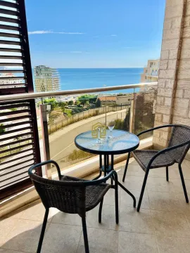 Furnished terrace with a table, chairs, and sea view. - image 2