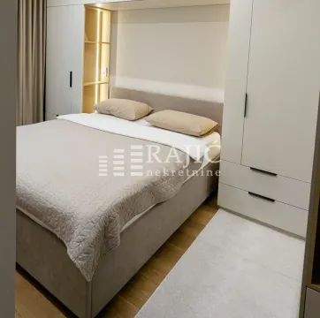 Modern bedroom with a double bed and built-in wardrobes. - image 11