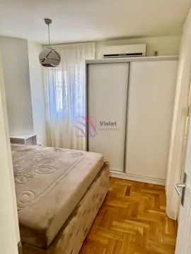 Bedroom with a double bed, large wardrobe, and parquet flooring. - image 12
