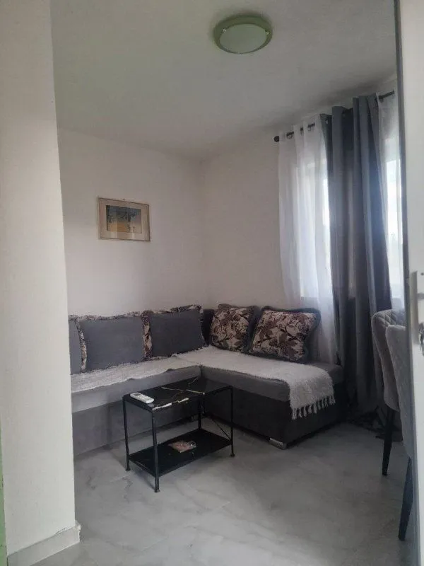 Small living room with a corner sofa and a coffee table.