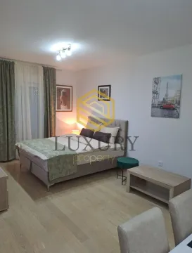 Furnished bedroom with a double bed and wooden flooring. - image 7