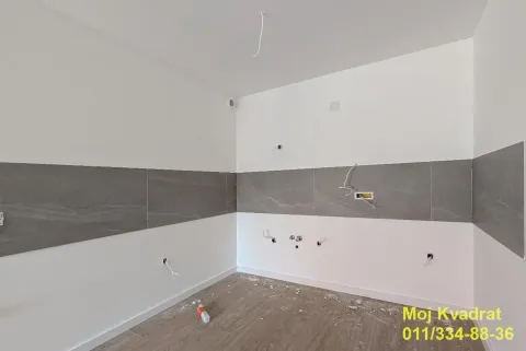 Prazna prostorija sa sivim zidnim pločicama i instalacijama u izgradnji. - image 4