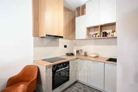 Modern corner kitchen with wooden elements and built-in appliances. - image 7