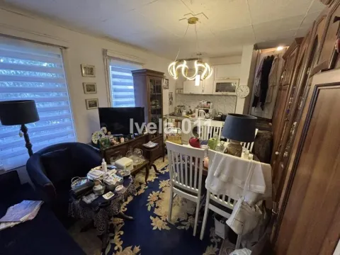 Living room with a dining area and an open layout towards the kitchen. - image 5