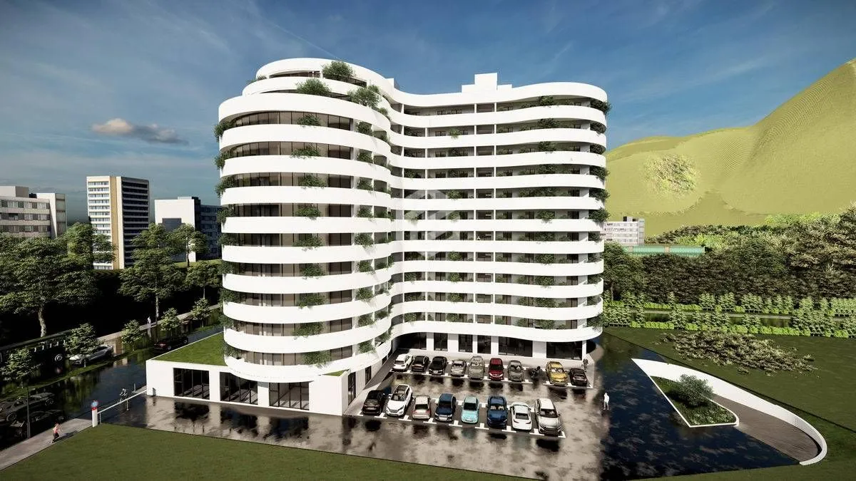 Spoljašnji izgled moderne stambene zgrade sa terasama i parkingom.