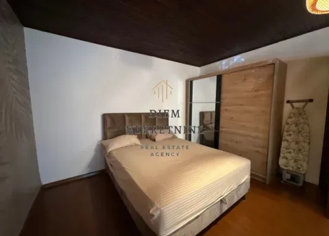 Bedroom with a double bed, wardrobe, and wooden ceiling. - image 9
