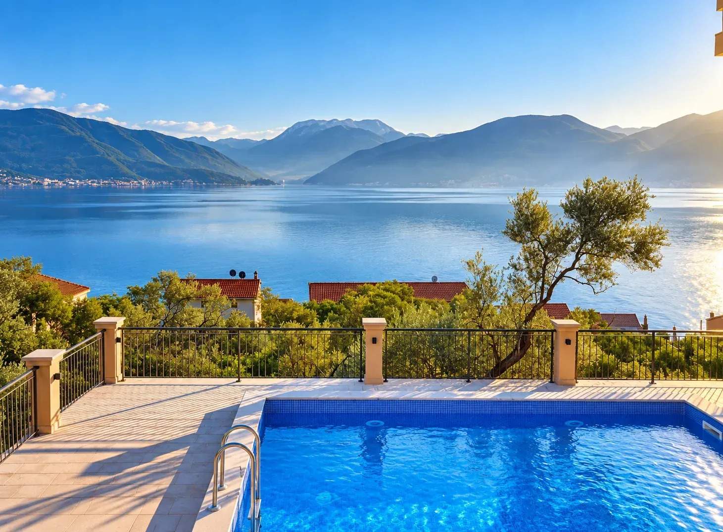 Terrace with a swimming pool and views of the sea and mountains.