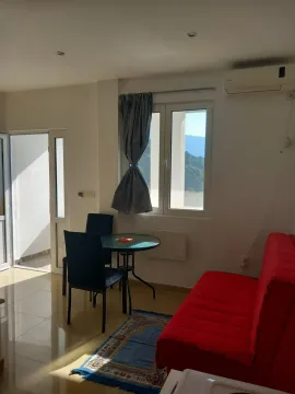 Living room with sofa, dining table, and access to the terrace. - image 3