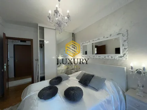 Modern bedroom with a double bed, wardrobe, and decorative mirror. - image 12