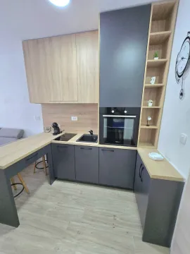 Moderna kuhinja sa drvenim elementima i ugrađenom rernom. - image 4