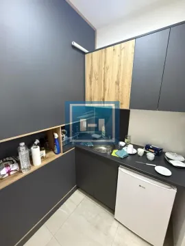 Small kitchen with dark cabinets and wooden details. - image 13