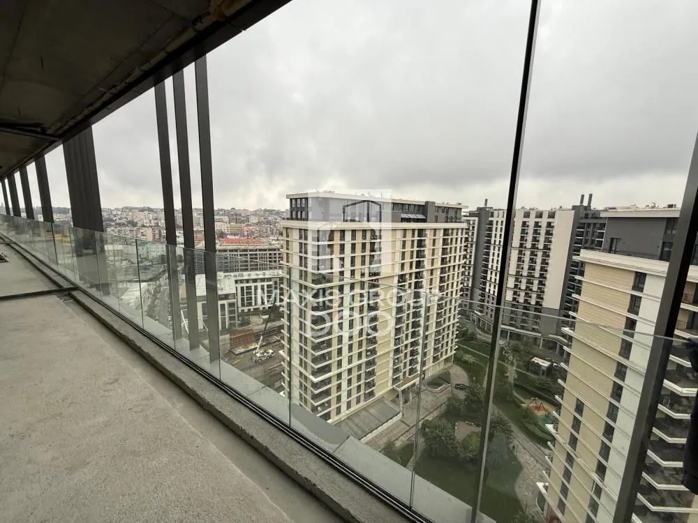 View of city buildings from a spacious balcony.