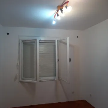 Empty room with white walls, a window with blinds, and a ceiling light fixture. - image 4